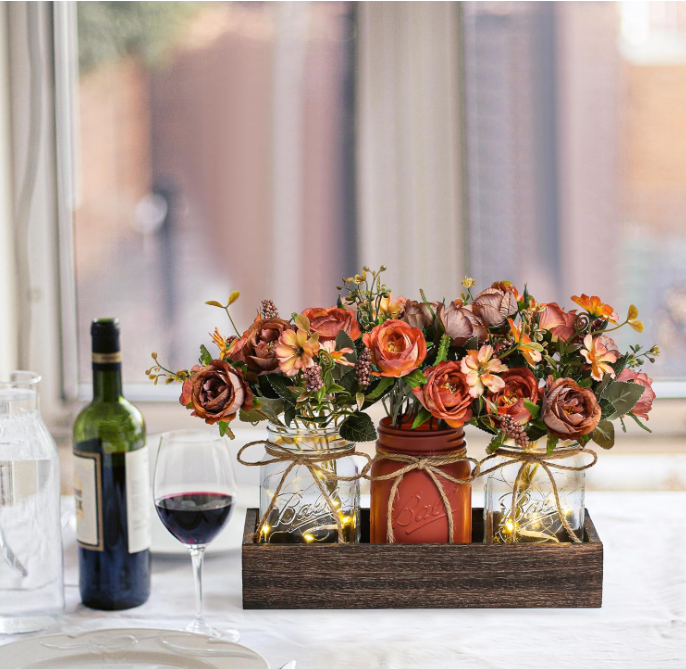 Elevate your interior décor with this sophisticated artificial flower arrangement, complete with a stylish pot and complementary small bulbs.